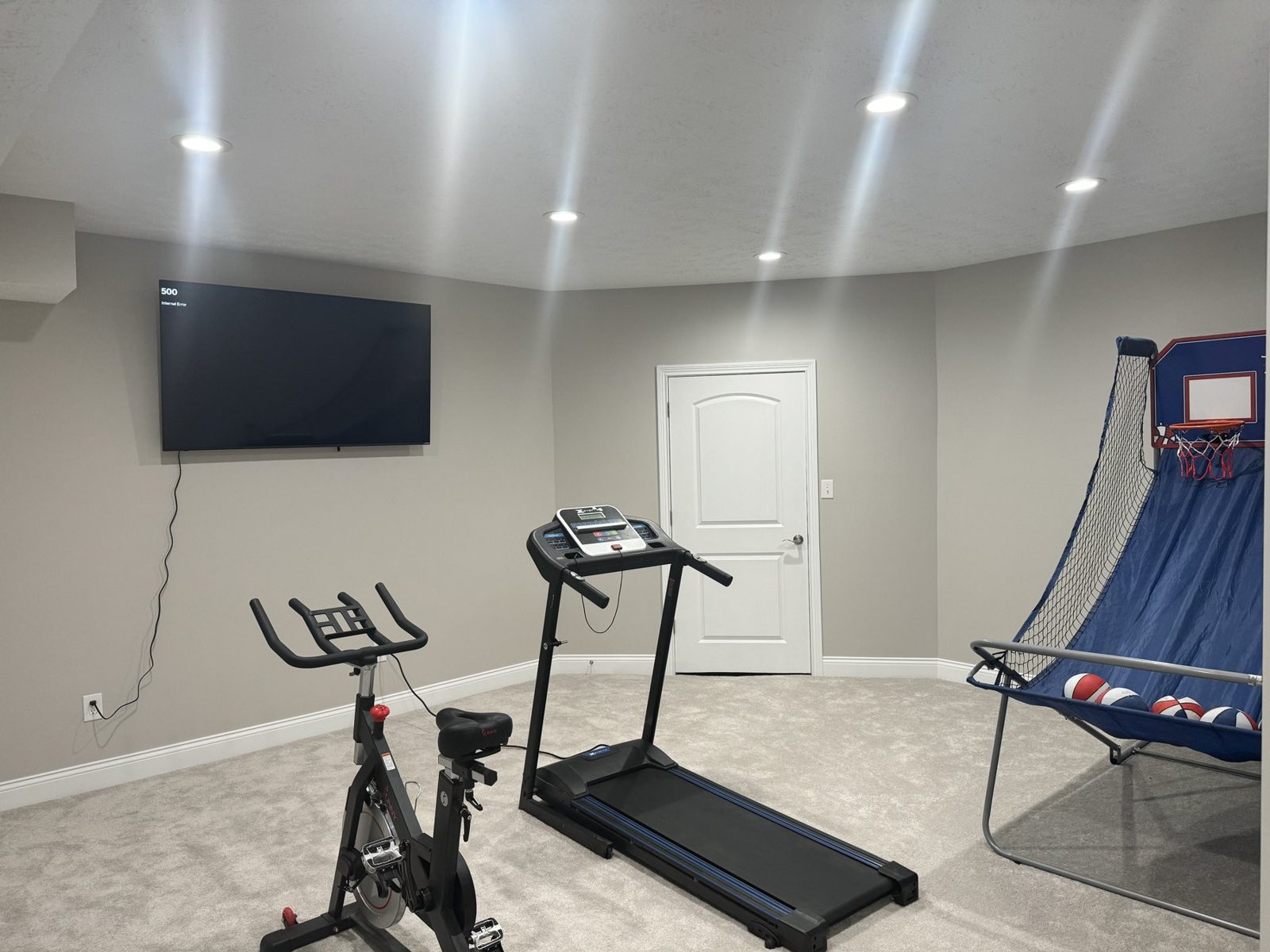 Finished basement home gym with a treadmill and exercise bike