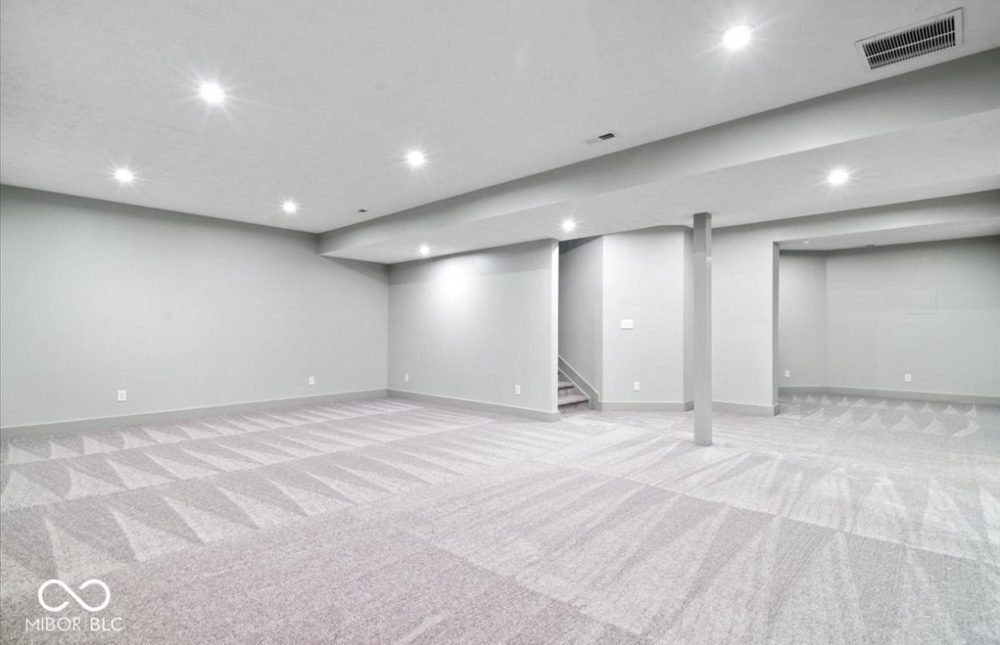 Finished open basement with recessed lighting and new carpet