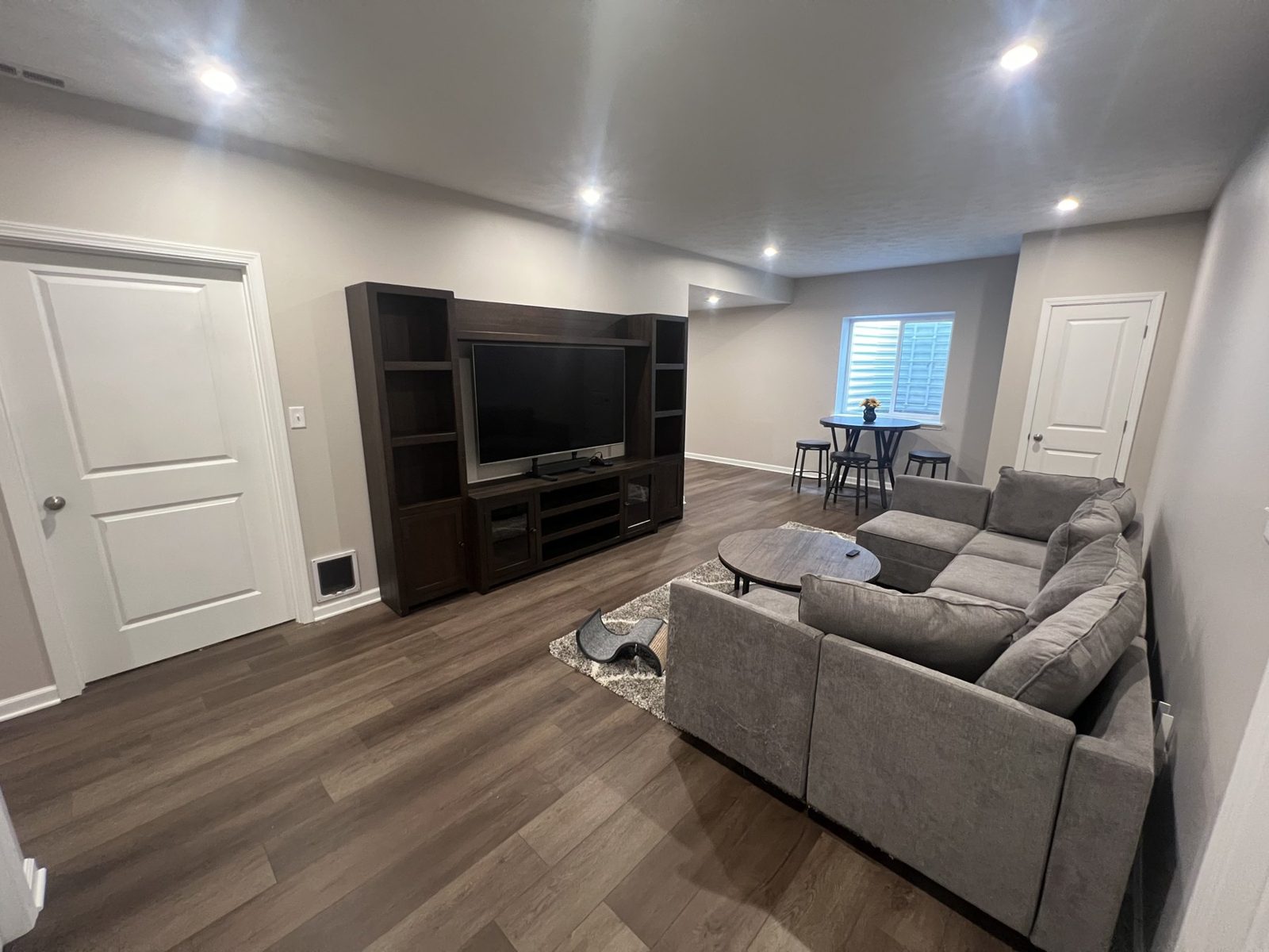 Finished basement with a built in television wall and sectional