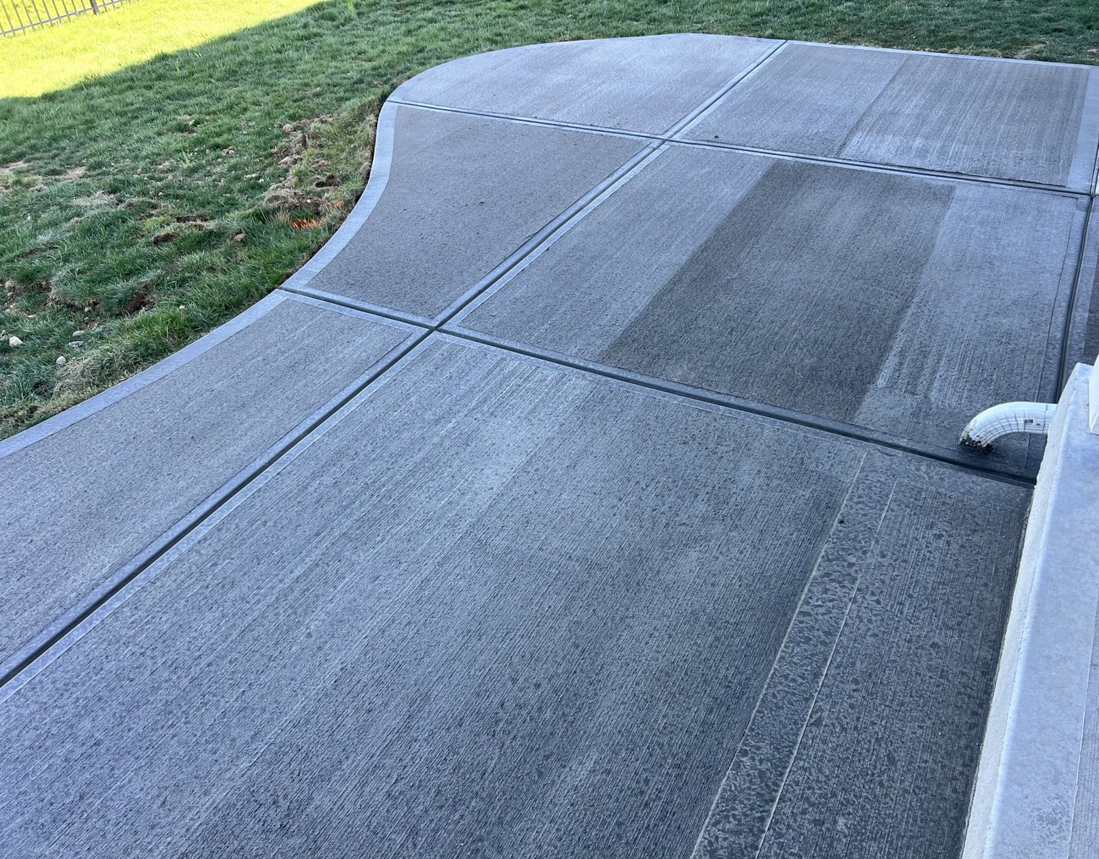 Newly poured concrete driveway running to the street