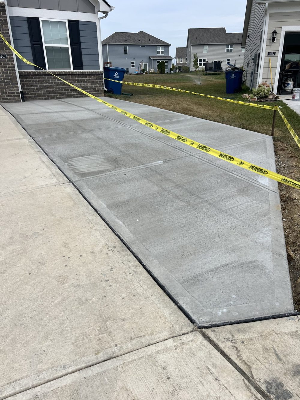 New concrete driveway taped off while it cures