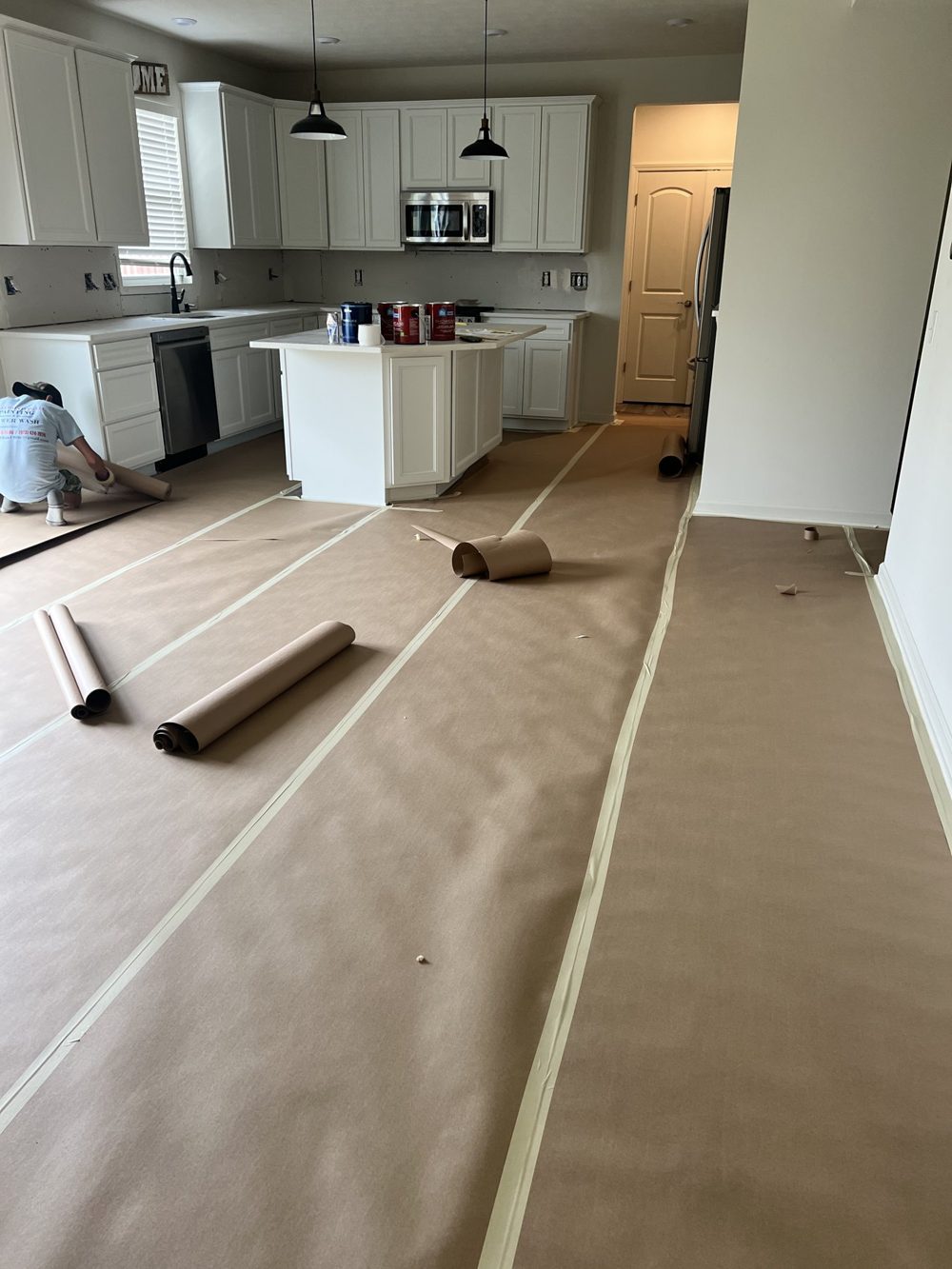 Floors papered and taped through a kitchen before painting