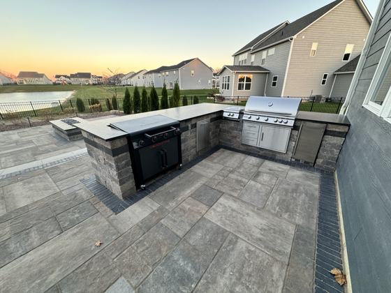 Outdoor kitchen and fire pit work by OnCall Home Co.