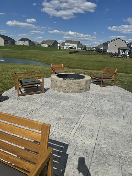 Outdoor kitchen and fire pit work by OnCall Home Co.