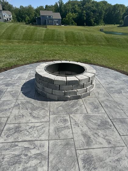 Outdoor kitchen and fire pit work by OnCall Home Co.