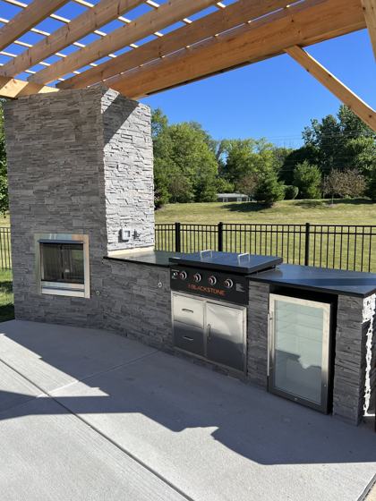 Outdoor kitchen and fire pit work by OnCall Home Co.