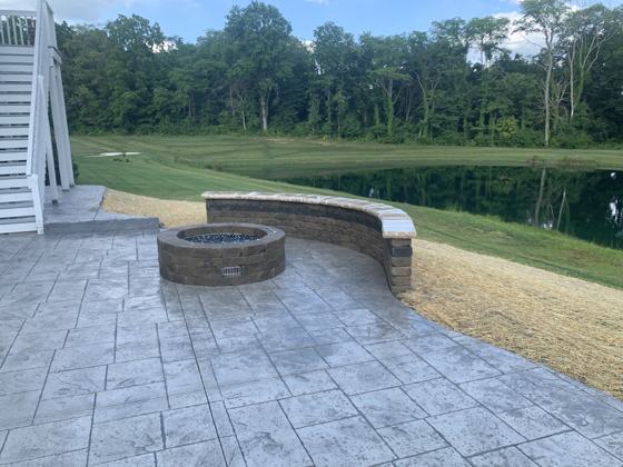 Outdoor kitchen and fire pit work by OnCall Home Co.