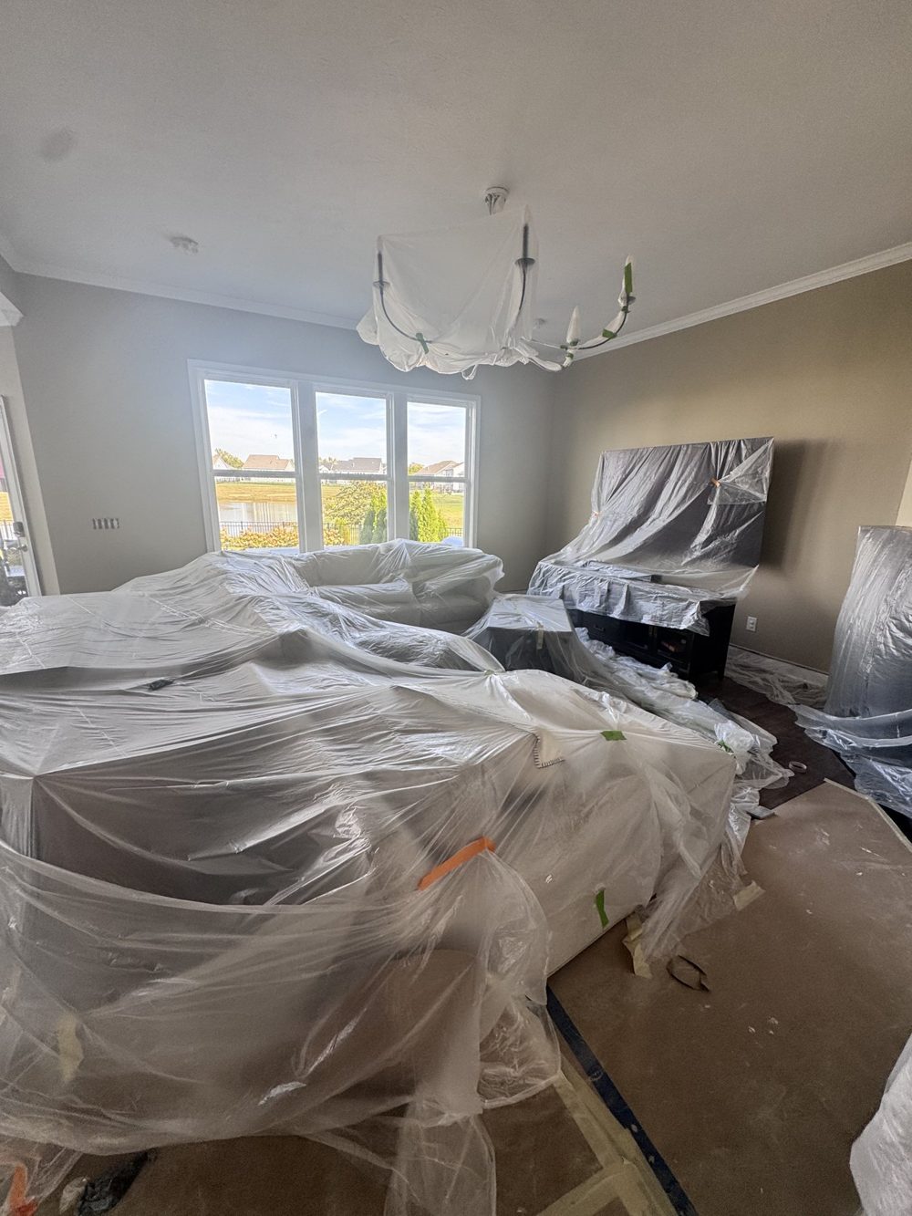 Furniture wrapped and floors covered before an interior repaint