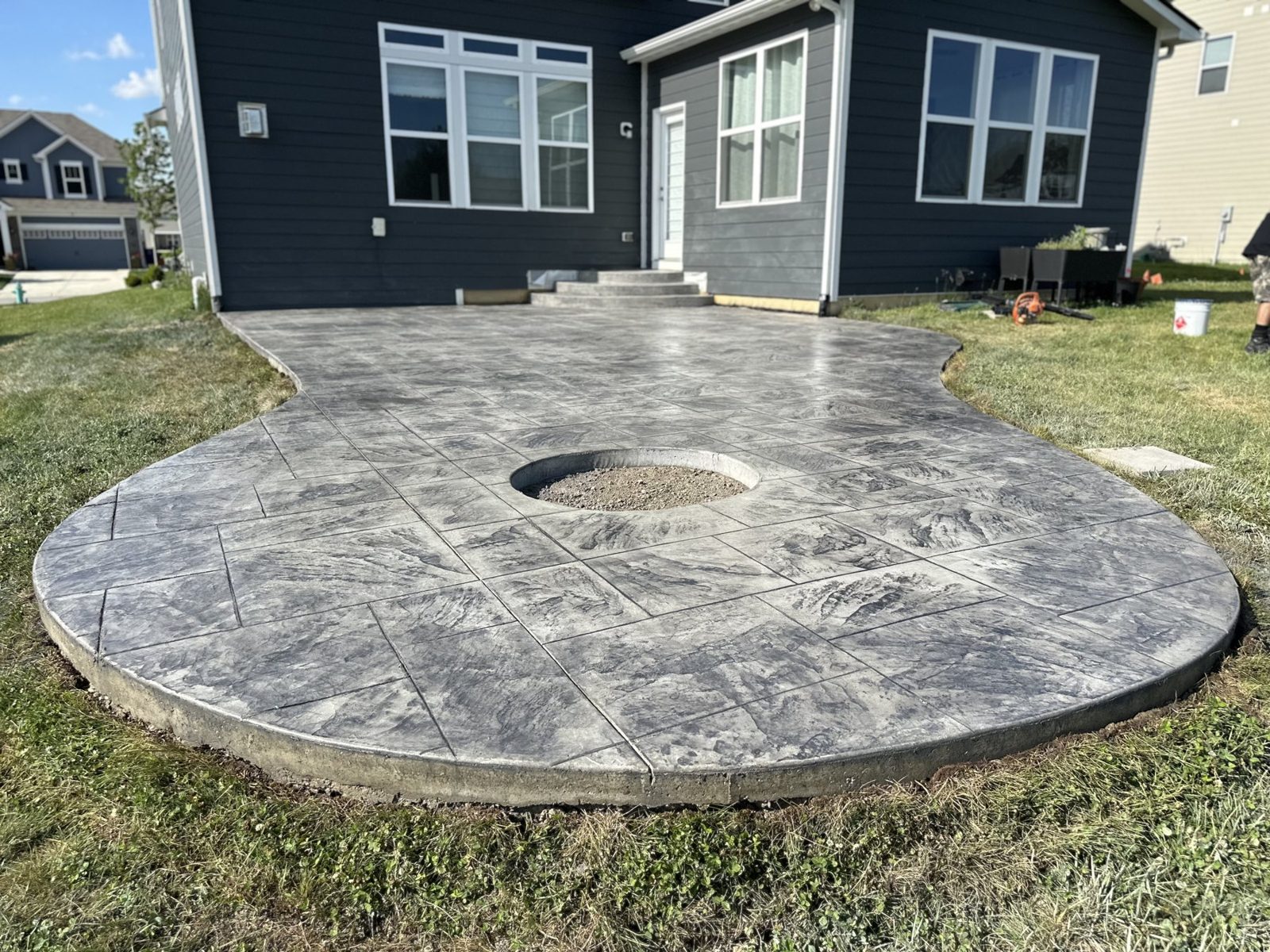 Round stamped patio with a recessed fire pit ring