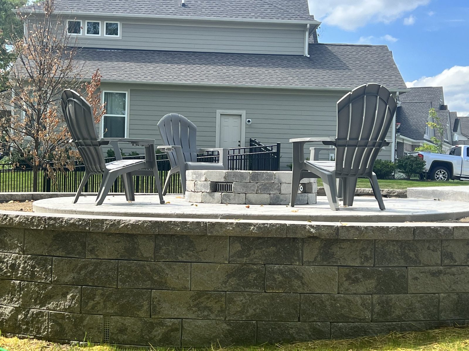 Finished stamped patio with a block sitting wall and outdoor seating