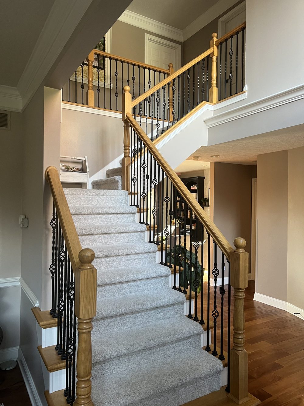 Staircase with painted risers and iron balusters